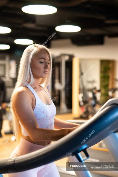 Blonde in the gym — On the treadmill