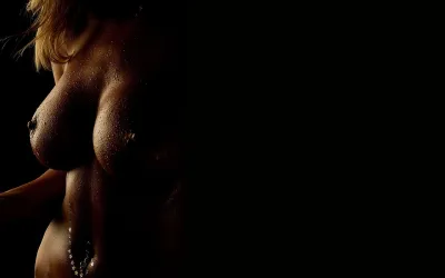 Female breast erotica — Naked girls on a dark background